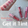 Set of lip tint products with visible brand names on a light surface.